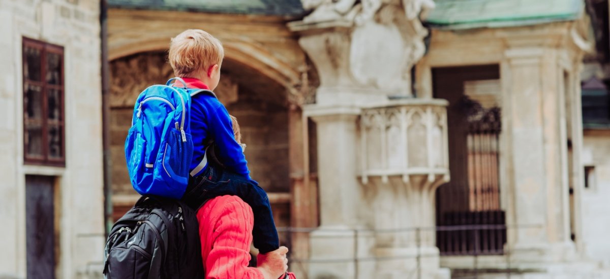 a child on a parents shoulders in Italy
