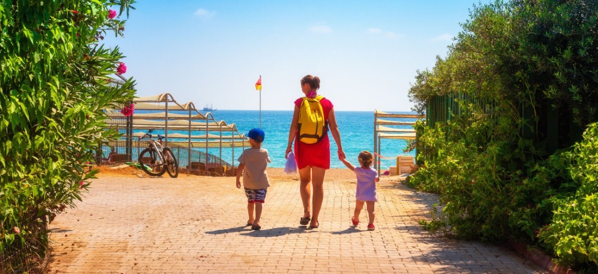 family waling towards the beach